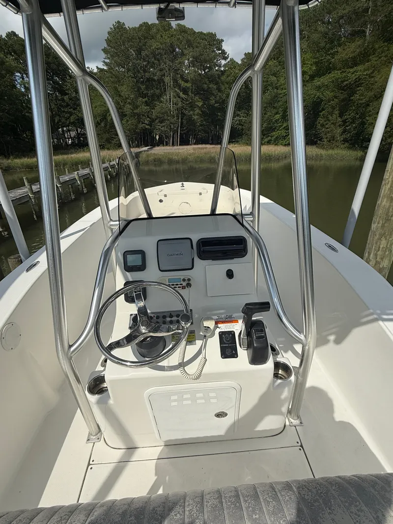 Slide: The Image of Center console of a 2012 Sundance NX 21 boat with steering wheel and controls. - 6