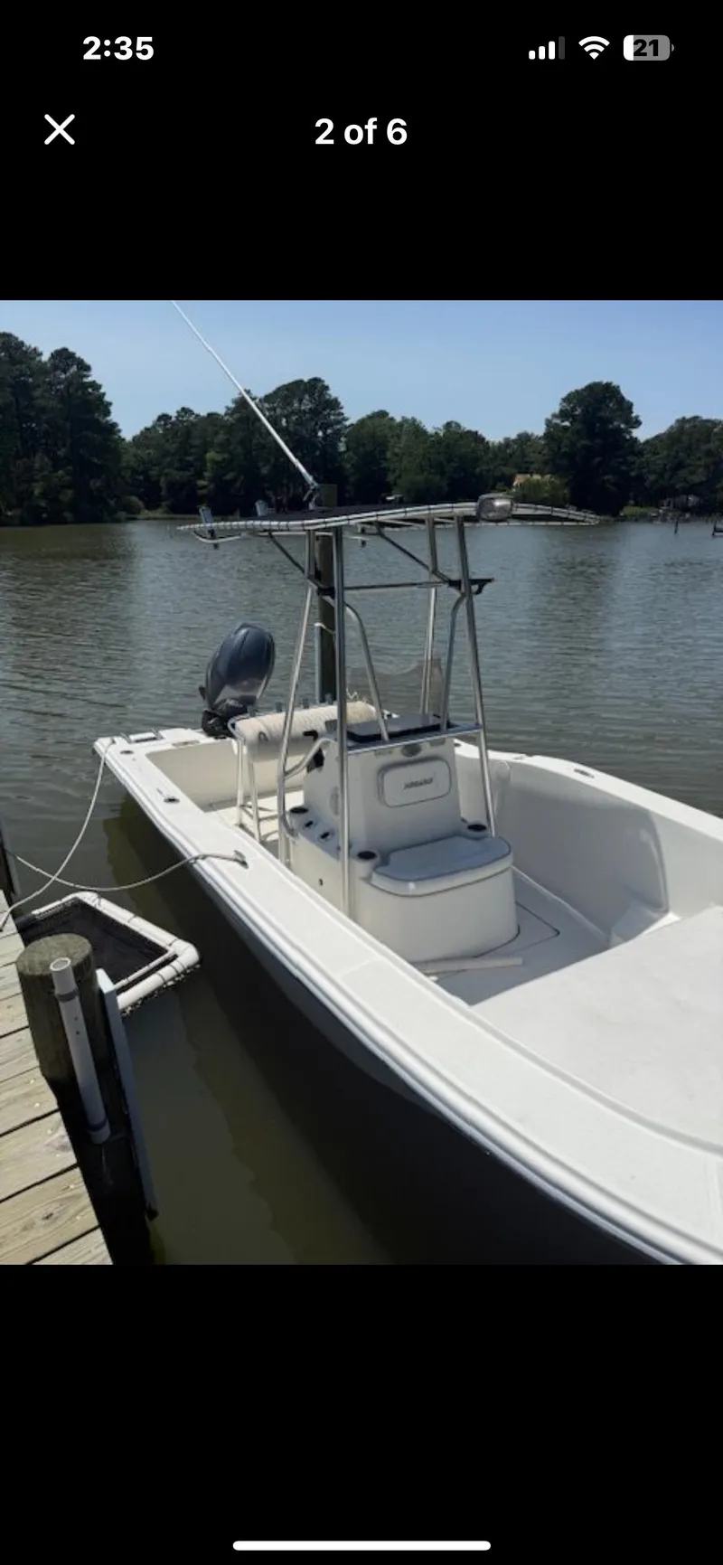 Slide: The Image of 2012 Sundance NX 21 boat docked on a calm lake. - 7