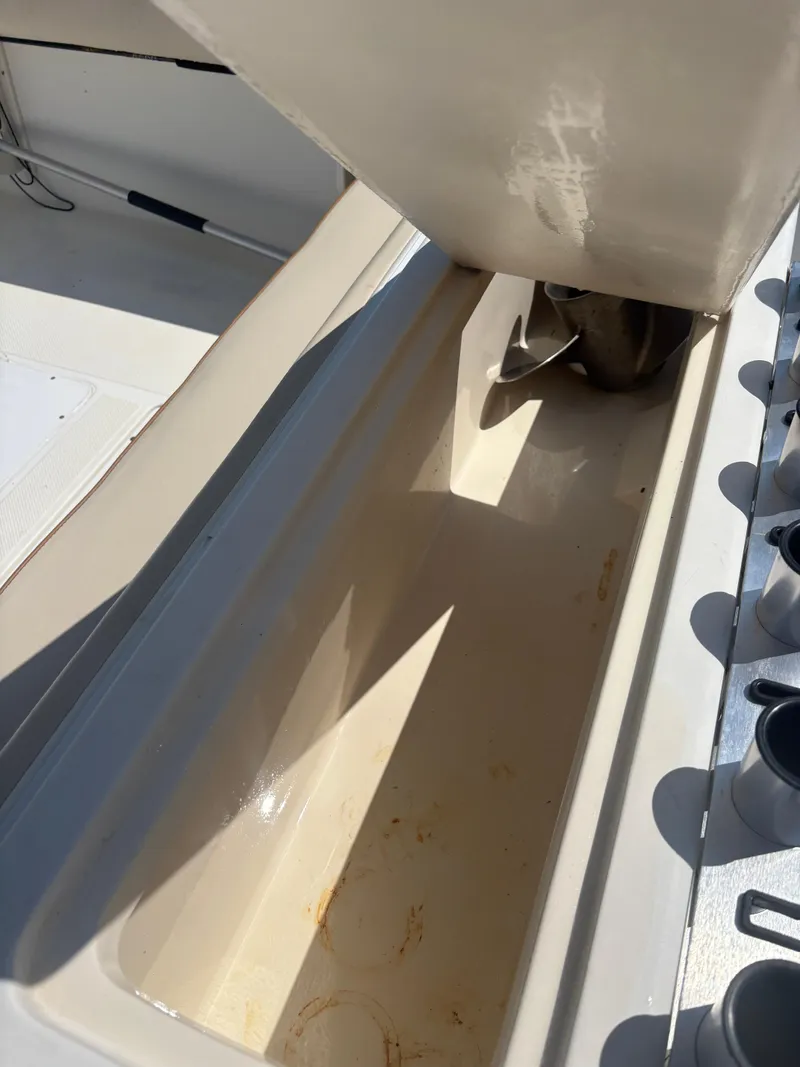 Slide: The Image of Open storage compartment on a 2000 Key West 2300 Bluewater boat, showing interior details. - 10