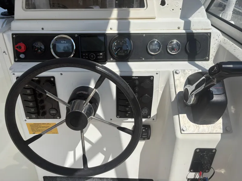 Slide: The Image of Steering console of a 2000 Key West 2300 Bluewater boat with GPS and controls. - 15