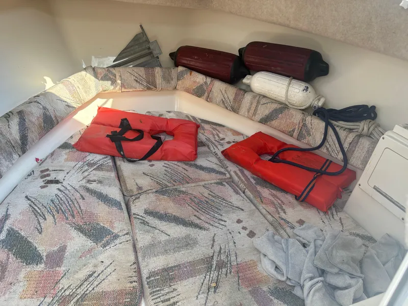 Slide: The Image of Interior of 2000 Key West 2300 Bluewater boat with life jackets and fenders. - 18