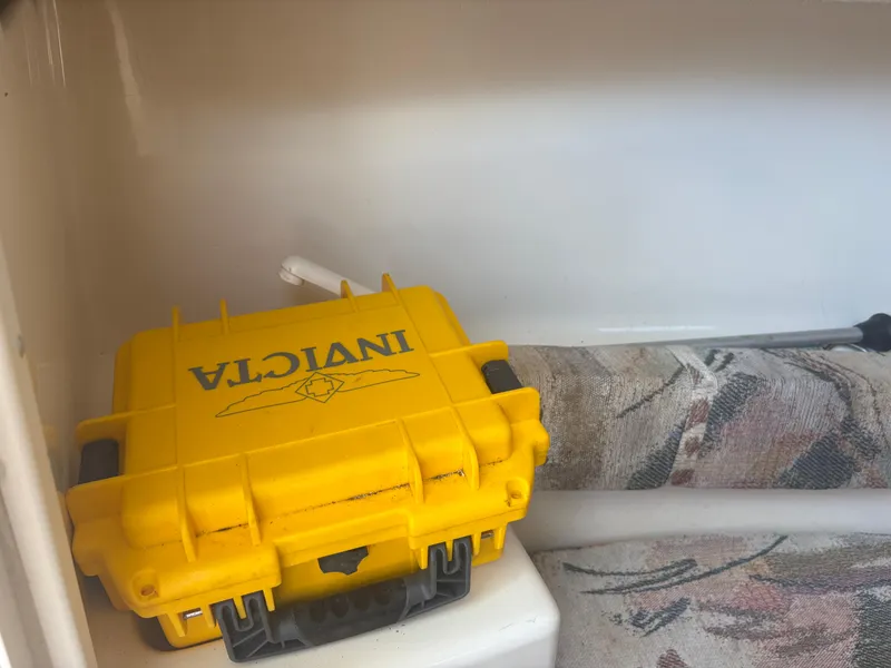 Slide: The Image of Yellow Invicta case inside a 2000 Key West 2300 Bluewater boat compartment. - 19