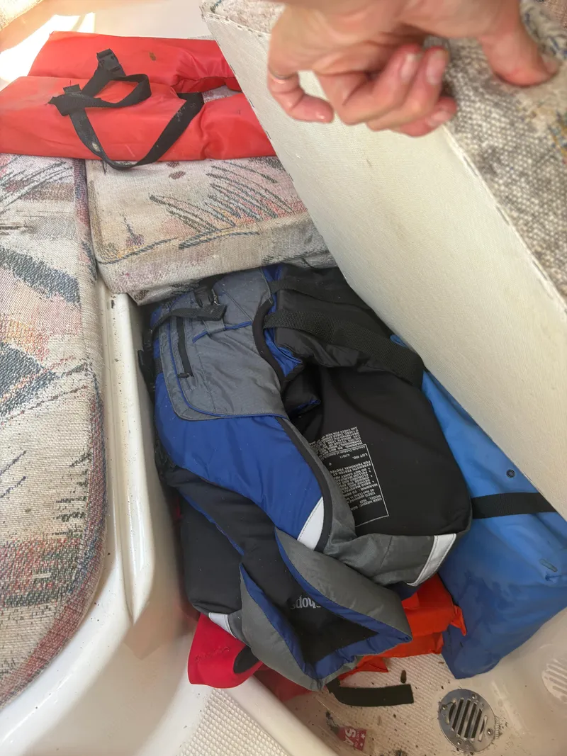 Slide: The Image of Life jackets stored on a 2000 Key West 2300 Bluewater boat, with visible seating area. - 21