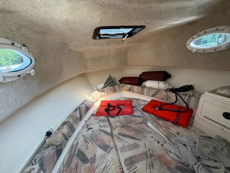Slide: The Image of Interior of 2000 Key West 2300 Bluewater boat with life jackets and cushions. - 22