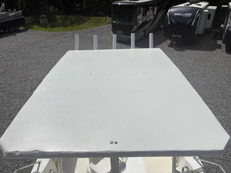 Slide: The Image of Top view of a 2000 Key West 2300 Bluewater boat in a gravel lot. - 26