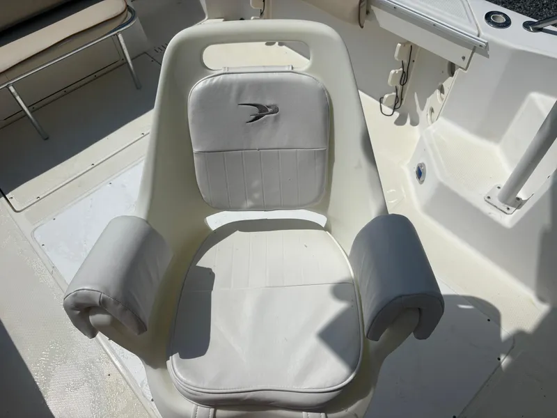 Slide: The Image of Captain's chair on a 2000 Key West 2300 Bluewater boat, featuring cushioned armrests. - 27