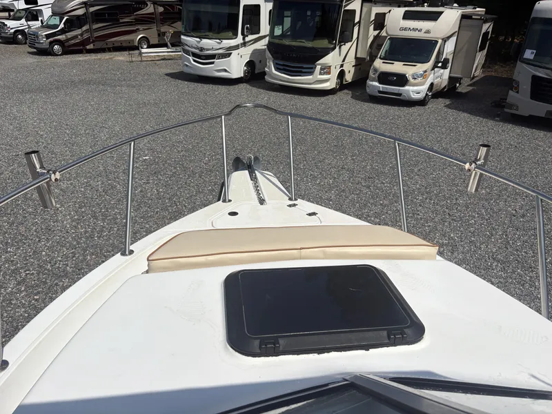 Slide: The Image of Bow view of 2000 Key West 2300 Bluewater boat, parked near RVs. - 28