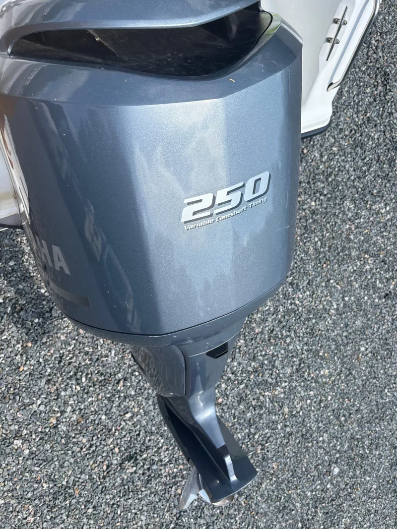 Slide: The Image of Yamaha 250 outboard motor on Key West 2300 Bluewater, 2000 model, on gravel surface. - 29