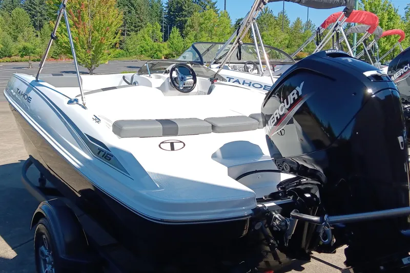 Slide: The Image of 2025 Tahoe T16 boat with Mercury engine, parked outdoors on a sunny day. - 3