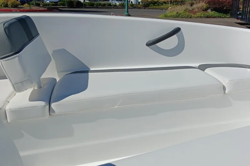Slide: The Image of 2025 Tahoe T16 boat interior with white cushioned seating and grab handle. - 5