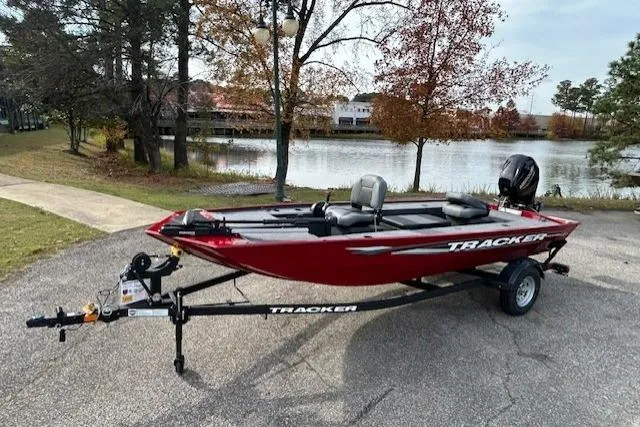 The Image of 2025 Tracker Panfish 17 boat on trailer by a scenic lake. - 0