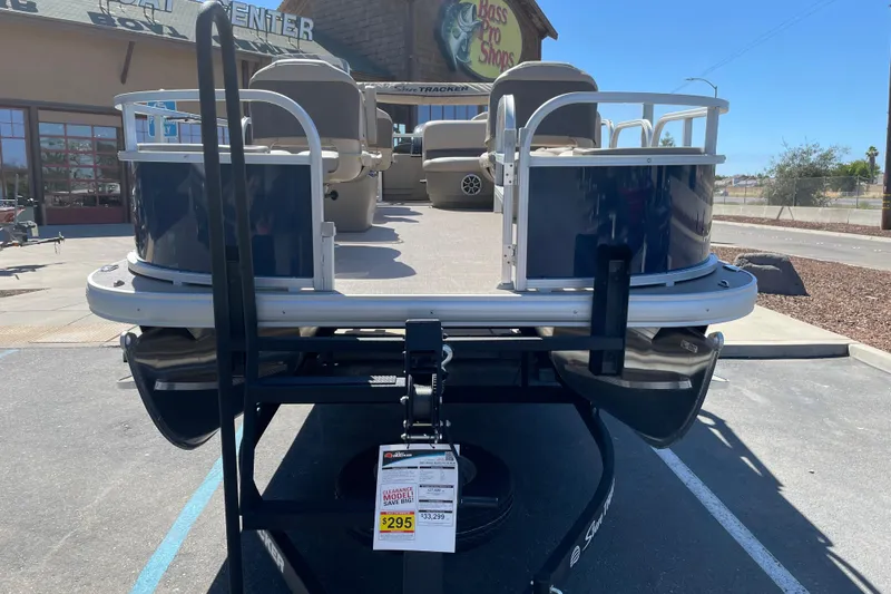 Slide: The Image of 2025 Sun Tracker Bass Buggy 18 DLX pontoon boat displayed at Bass Pro Shops. - 3