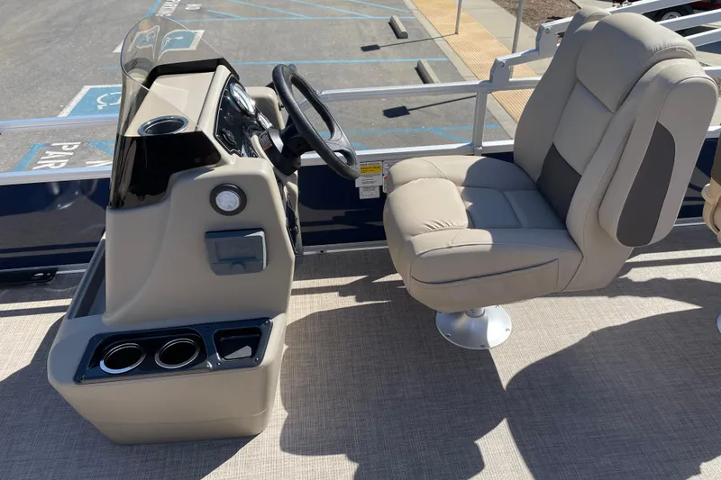 Slide: The Image of 2025 Sun Tracker Bass Buggy 18 DLX boat interior with steering console and comfortable seating. - 8