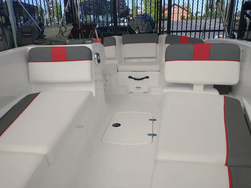 Slide: The Image of 2025 Tahoe T16 boat interior with white and gray seating, red accents, and spacious layout. - 2