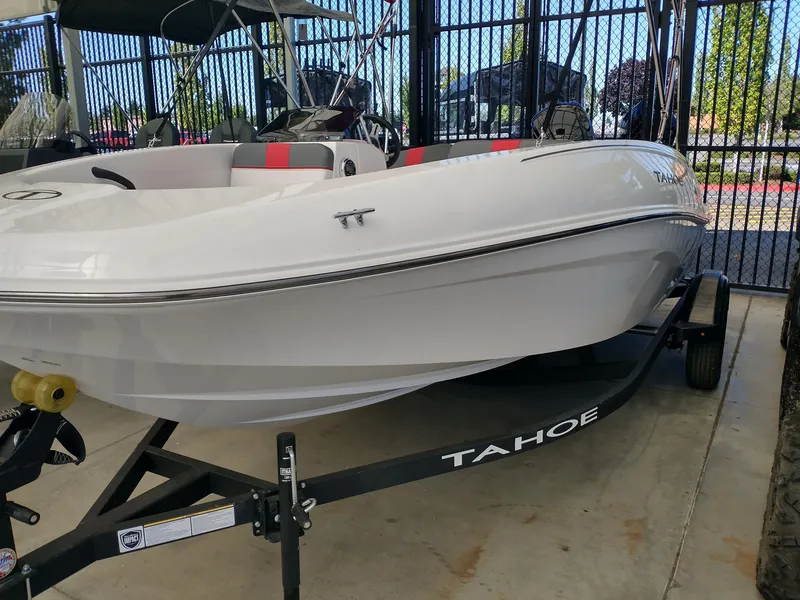 Slide: The Image of 2025 Tahoe T16 boat on trailer, white exterior, parked in a showroom. - 3