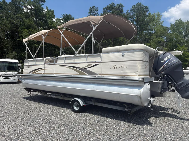 Slide: The Image of 2009 Avalon Paradise 24' pontoon boat with Yamaha outboard motor on trailer. - 1