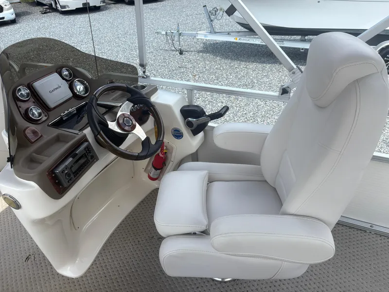 Slide: The Image of Captain's chair and helm of 2009 Avalon Paradise 24' boat with steering wheel and controls. - 10