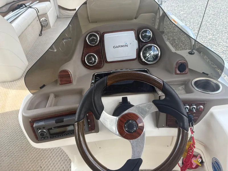 Slide: The Image of Steering console of 2009 Avalon Paradise 24' boat with Garmin navigation system. - 11