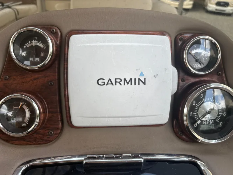 Slide: The Image of Dashboard of a 2009 Avalon Paradise boat featuring Garmin navigation and gauges. - 12