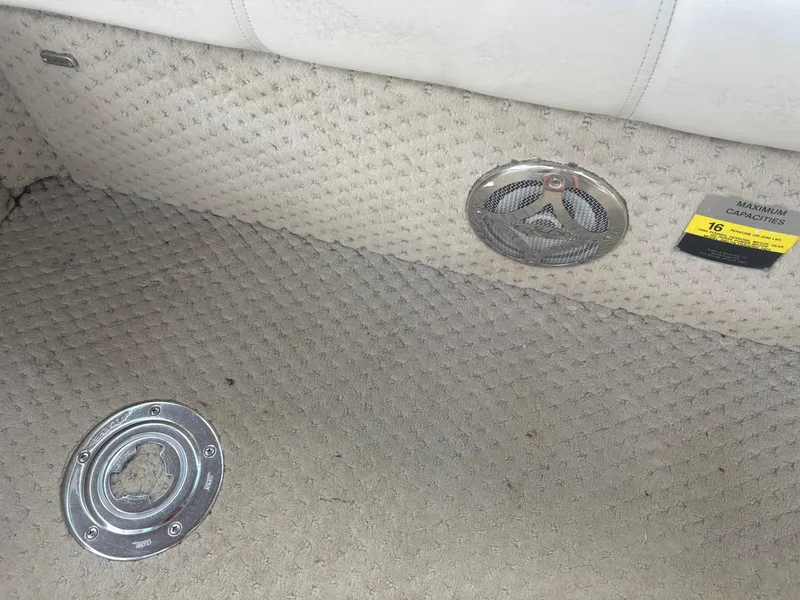 Slide: The Image of Interior of 2009 Avalon Paradise boat showing carpet, speaker, and capacity label. - 14