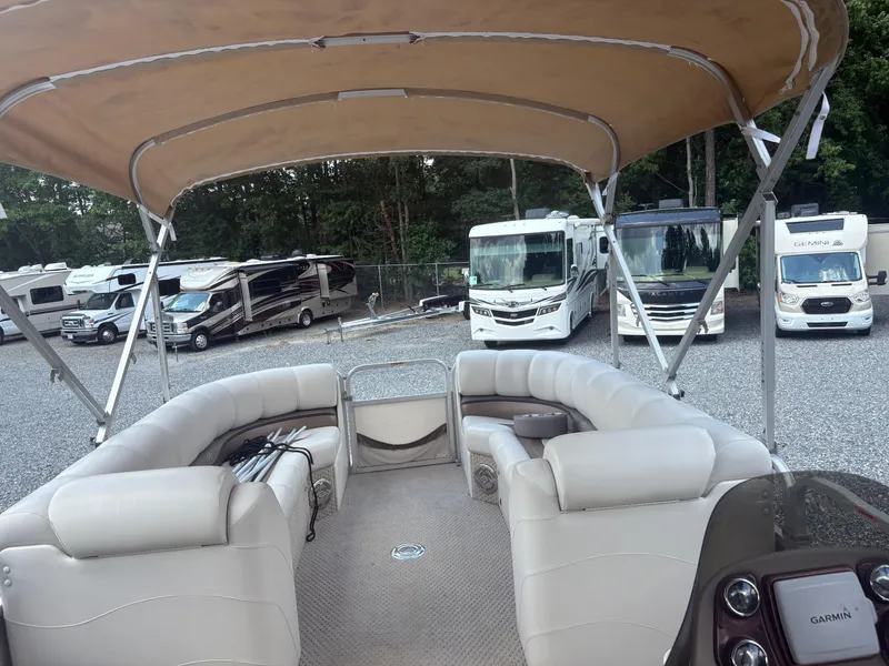 Slide: The Image of 2009 Avalon Paradise 24' pontoon boat with canopy, parked near RVs. - 16