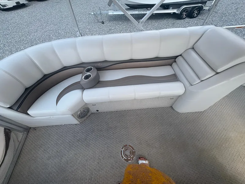 Slide: The Image of 2009 Avalon Paradise 24' boat interior with white seating and cup holders. - 17