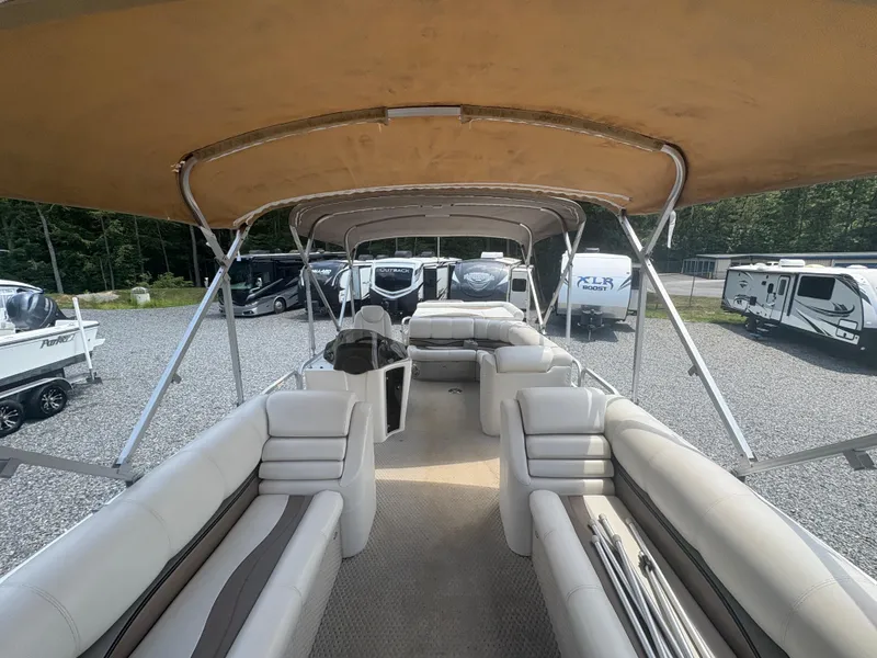 Slide: The Image of 2009 Avalon Paradise 24' pontoon boat interior with beige seating and canopy. - 19