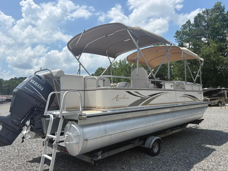 Slide: The Image of 2009 Avalon Paradise 24' pontoon boat with Yamaha motor, parked on a trailer. - 3