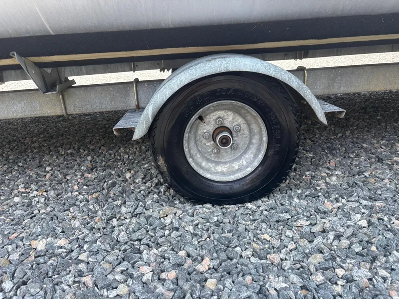 Slide: The Image of Flat tire on a 2009 Avalon Paradise 24' trailer, parked on gravel. - 4