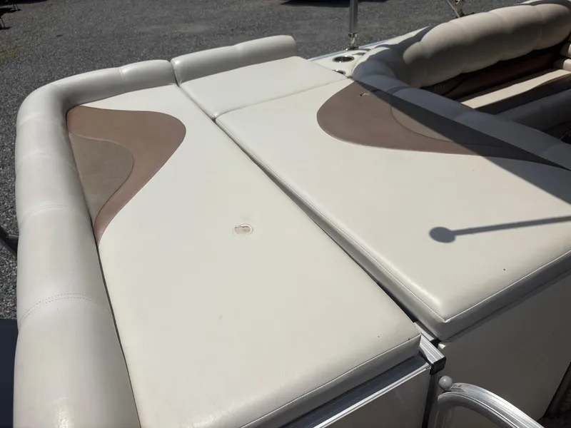 Slide: The Image of 2009 Avalon Paradise 24' boat seating with beige and brown upholstery, shown in outdoor setting. - 8