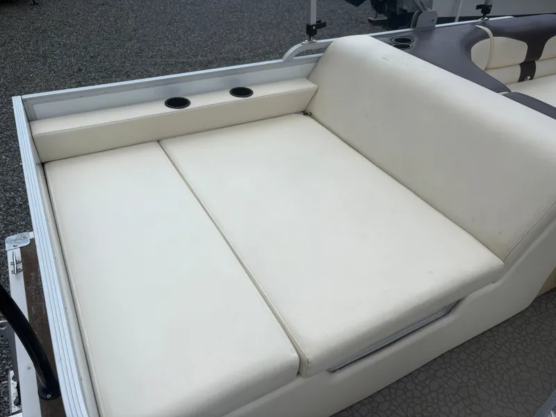 Slide: The Image of 2021 Lexington 321 boat seating area with cup holders, beige upholstery. - 10