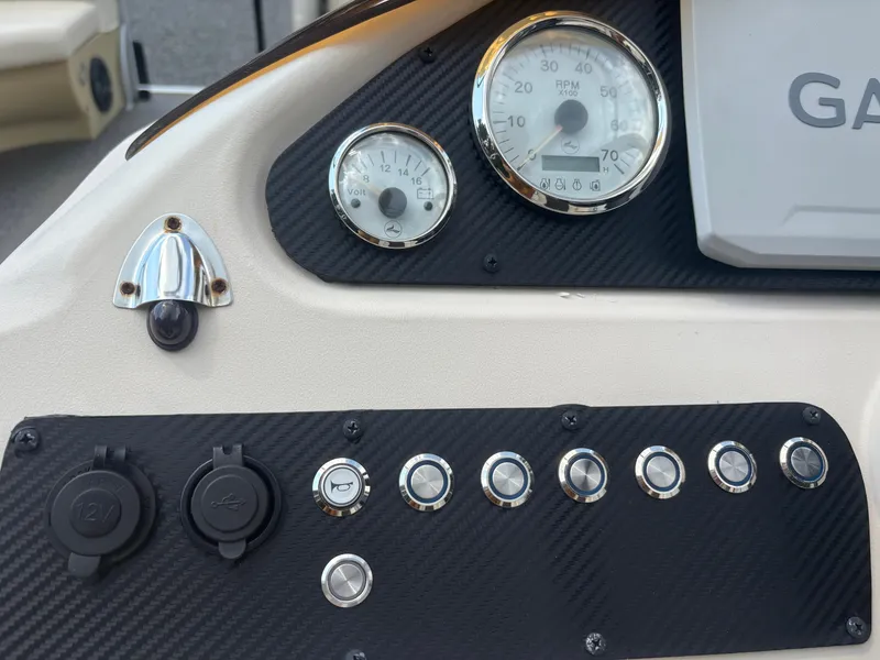Slide: The Image of Control panel of a 2021 Lexington 321 boat with gauges and switches. - 14