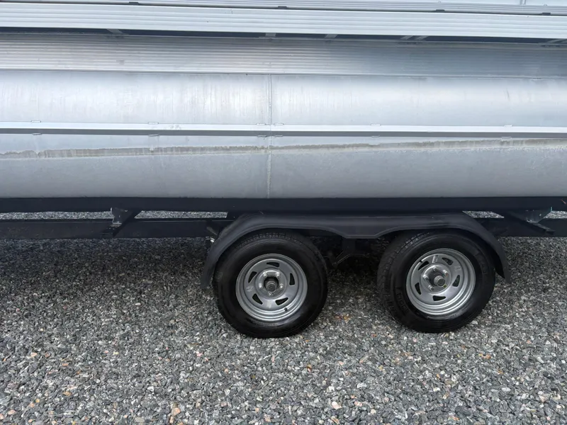 Slide: The Image of Trailer wheels of a 2021 Lexington 321 on gravel surface. - 3