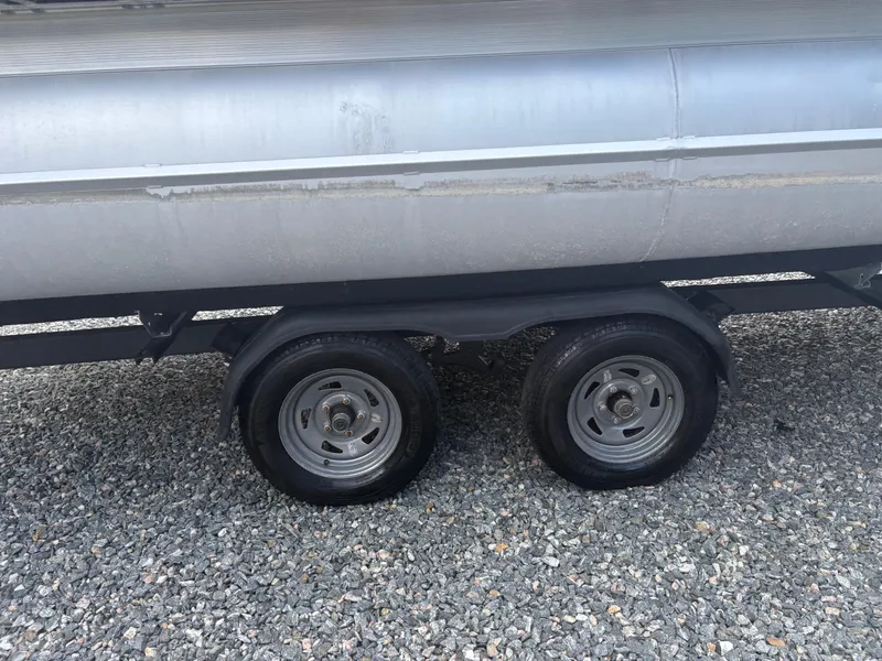 Slide: The Image of 2021 Lexington 321 trailer wheels on gravel surface. - 6
