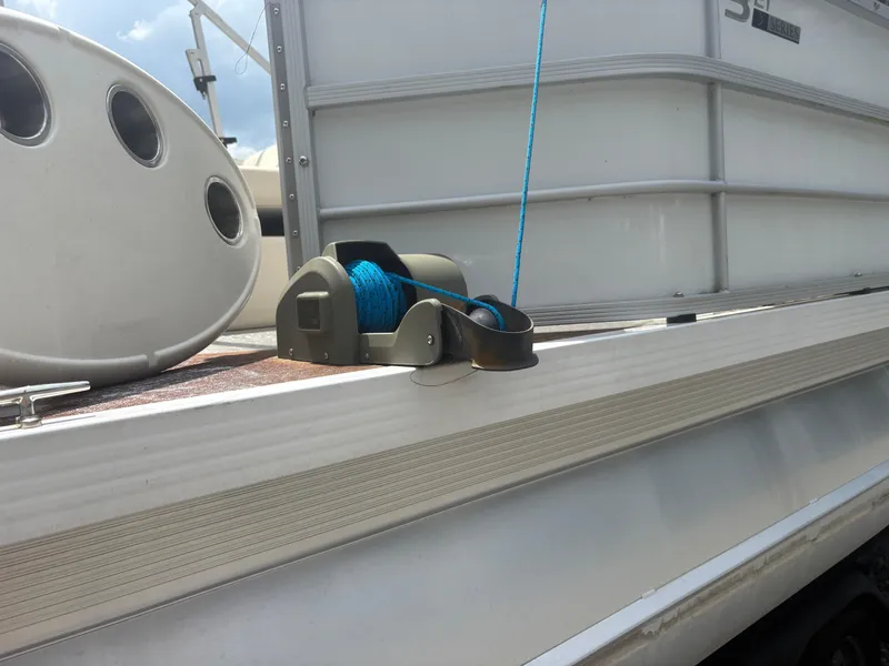 Slide: The Image of 2021 Lexington 321 boat deck with blue rope and winch. - 8