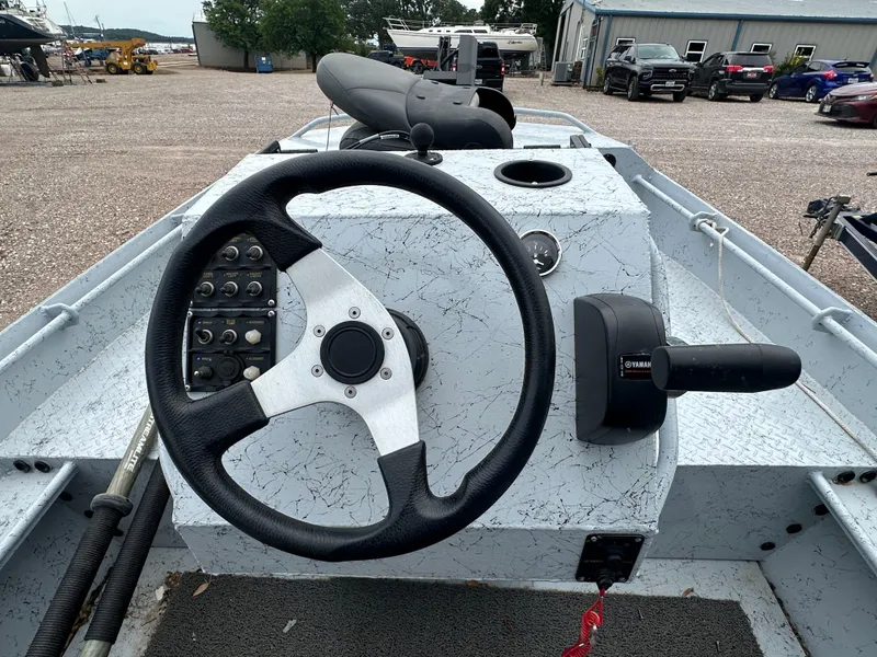 Slide: The Image of StealthCraft Stealthweld 18 boat dashboard with steering wheel and controls, 2023 model. - 12