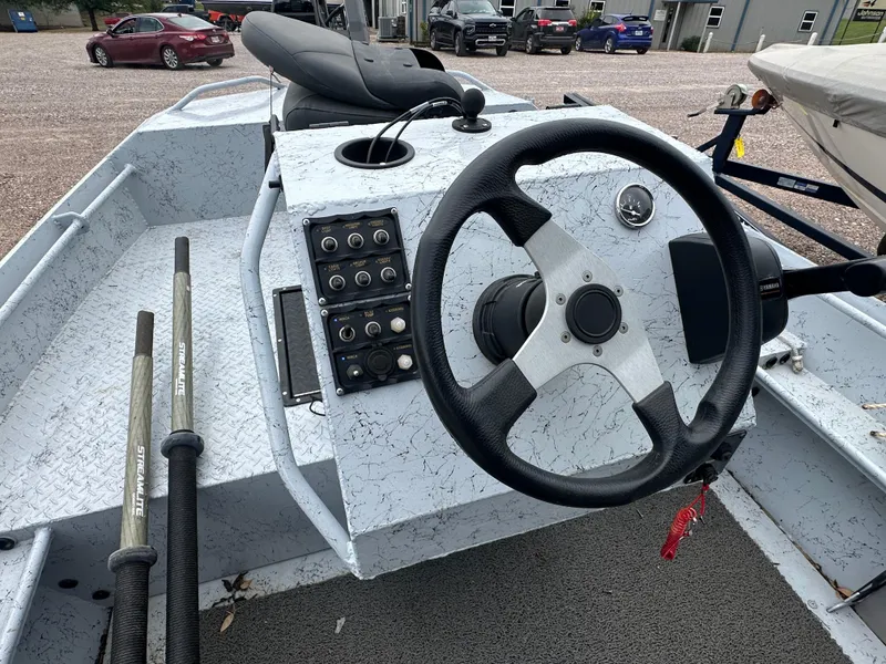 Slide: The Image of 2023 StealthCraft Stealthweld 18 boat interior with steering wheel and control panel. - 13