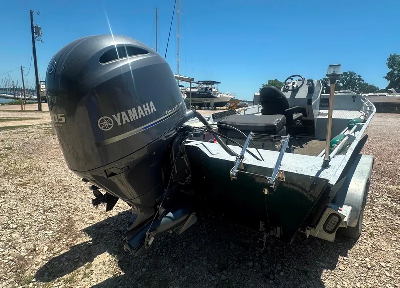 Slide: The Image of 2023 StealthCraft Stealthweld 18 boat with Yamaha outboard motor, parked on gravel. - 15