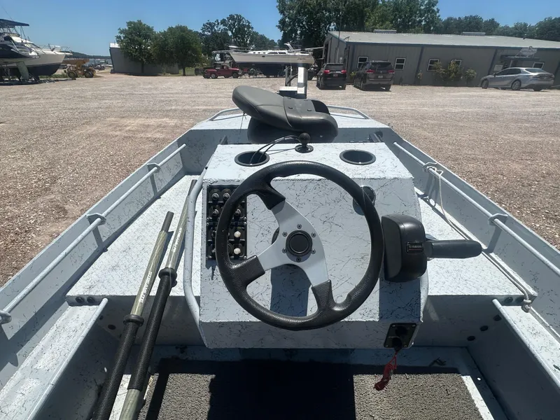 Slide: The Image of 2023 StealthCraft Stealthweld 18 boat interior with steering wheel and controls. - 18