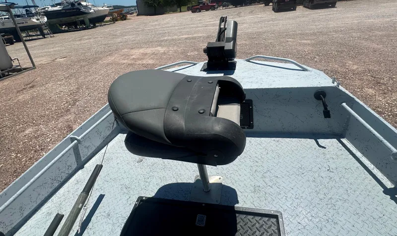 Slide: The Image of 2023 StealthCraft Stealthweld 18 boat interior with seat and equipment on a gravel lot. - 19