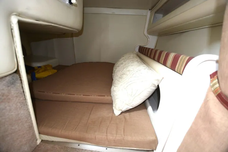 Slide: The Image of 1999 Rinker 270 Fiesta Vee cabin interior with cushions and pillow. - 15