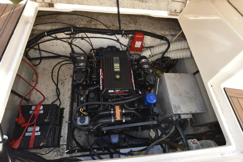 Slide: The Image of Engine compartment of a 1999 Rinker 270 Fiesta Vee boat with visible MerCruiser engine. - 19