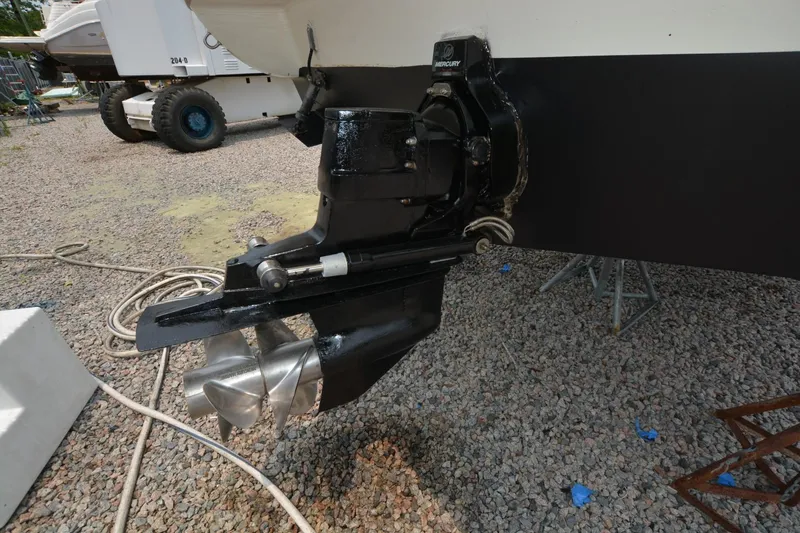 Slide: The Image of 1999 Rinker 270 Fiesta Vee boat propeller and drive system on gravel surface. - 7