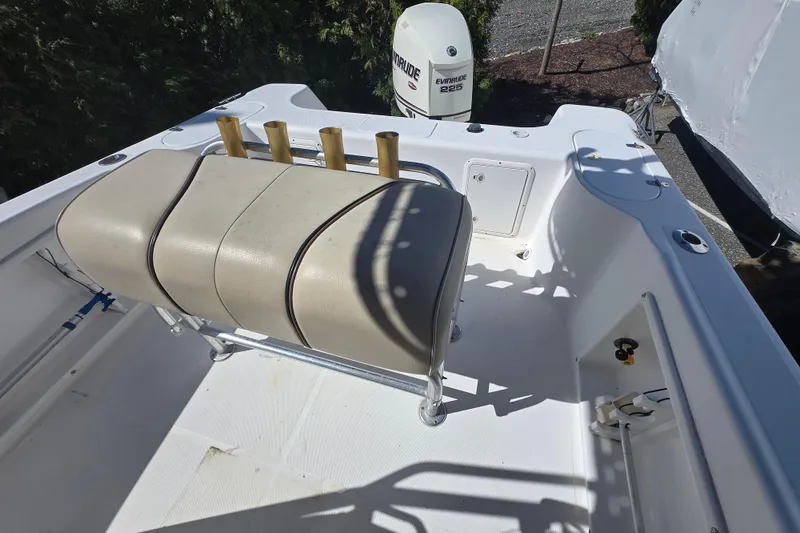 Slide: The Image of 1999 Century 2300 Center Console boat interior with seating and Evinrude 225 engine. - 18