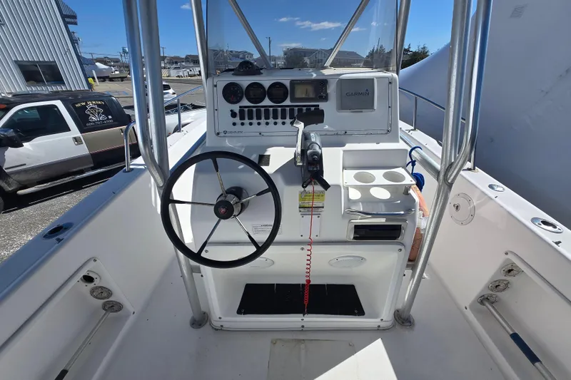 Slide: The Image of 1999 Century 2300 Center Console boat interior with steering wheel and navigation equipment. - 19