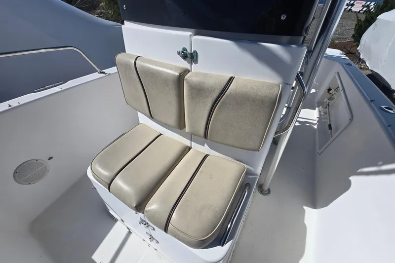 Slide: The Image of 1999 Century 2300 Center Console boat seating area with cushioned seats. - 20