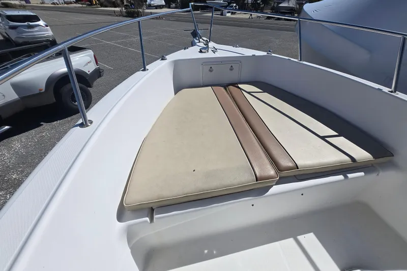 Slide: The Image of 1999 Century 2300 Center Console boat with cushioned seating area. - 21