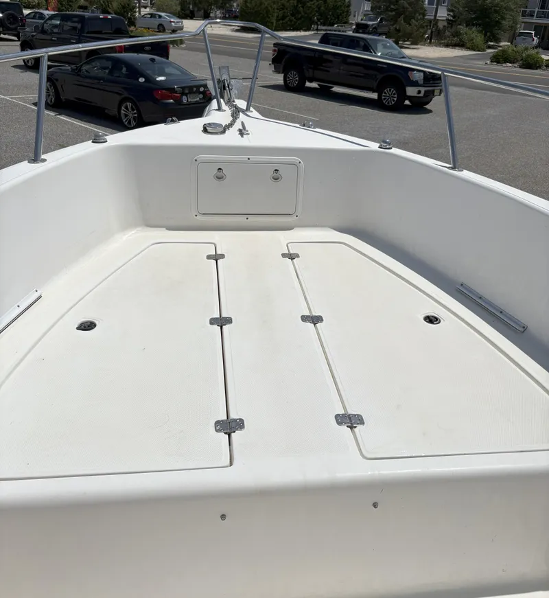 Slide: The Image of 1999 Century 2300 Center Console boat deck in a parking lot. - 9