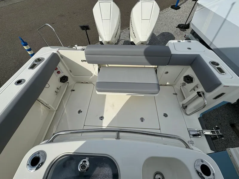 Slide: The Image of 2025 Boston Whaler 280 Outrage boat deck with seating and dual engines. - 10