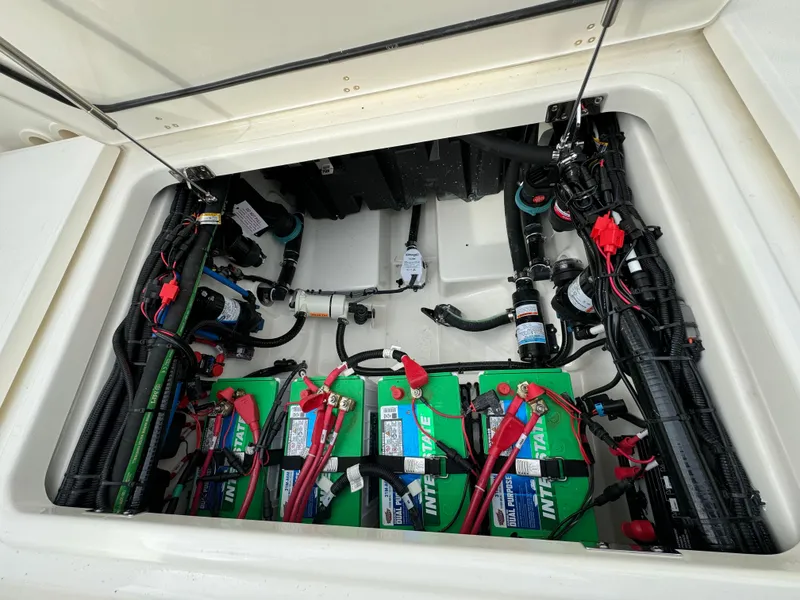 Slide: The Image of 2025 Boston Whaler 280 Outrage battery compartment with wiring and components. - 12
